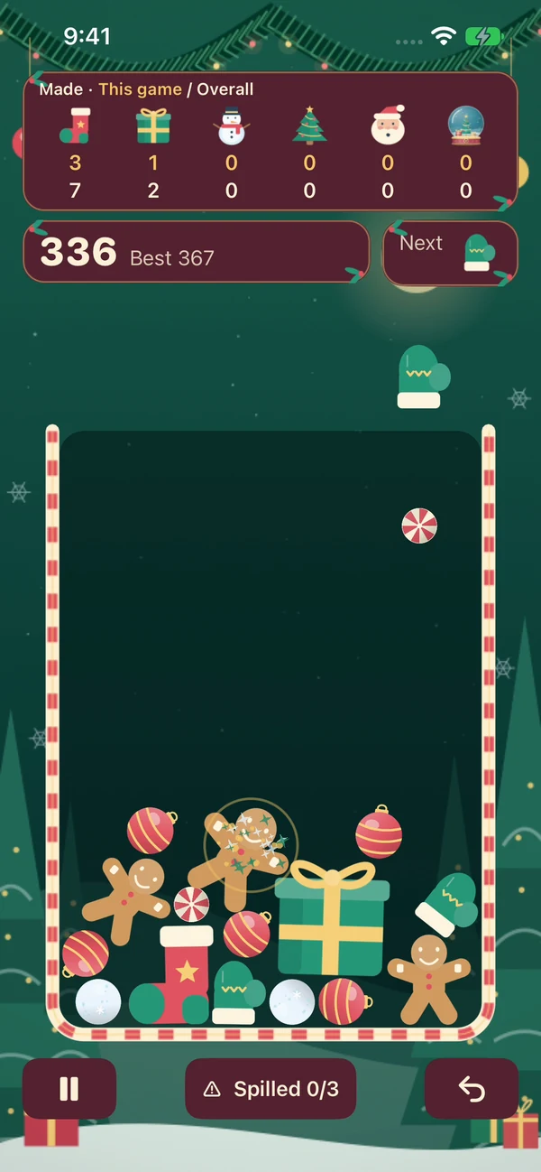 Christmas Drop development gameplay: peppermints, mittens, gingerbread, and a Present in a snowy evergreen scene.